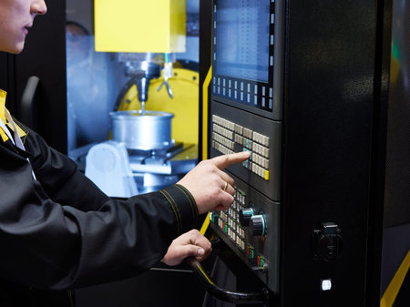 Worker controls the CNC machine