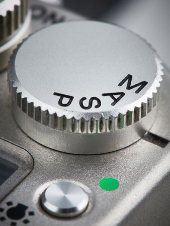 Mode control dial on SLR camera closeup verticalの写真素材