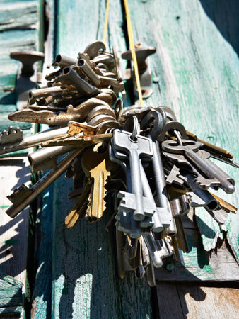 Bunch of old keys on a background of a green vintage wall