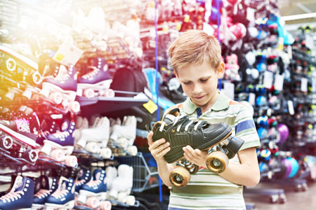 Boy with rollers in the store