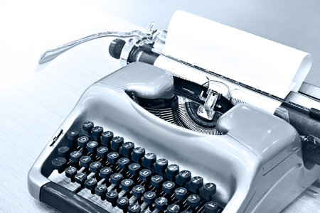 Green retro typewriter on wooden table