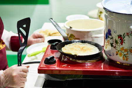 Cooking pancakes on the stoveの写真素材
