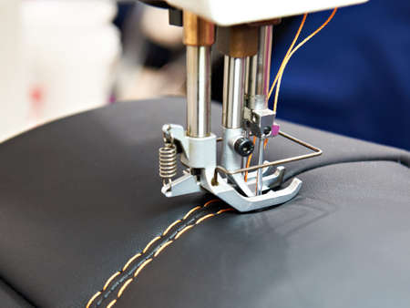 Sewing machine with red cloth button holesの写真素材