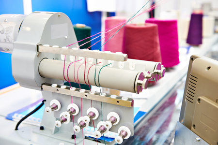 Bobbins with colored thread for industrial textile machines