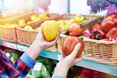 Buyer selects the bell peppers in the store