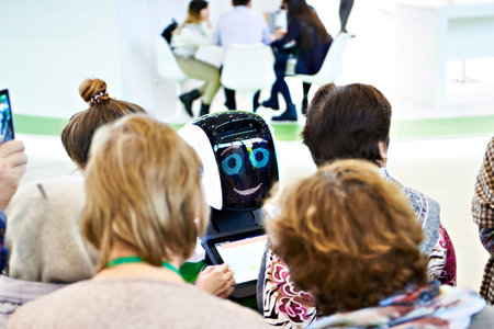 Robot information assistant among people at the exhibitionの写真素材