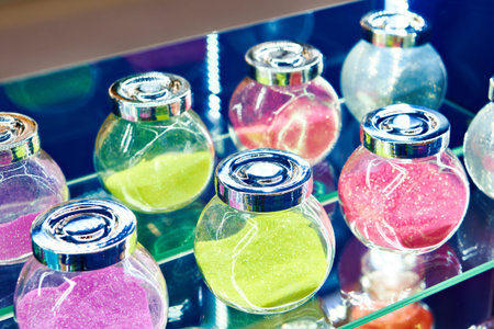 Jars with shiny decorative dyes in a display case