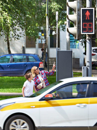 Mother and child stand at the crosswalk