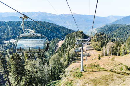 Ski lift with supports and chairs in the mountains on summerの写真素材