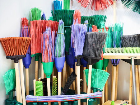 Colorful brooms for garden as household implement in the storeの写真素材