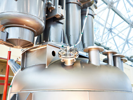 Dissolver with a hydraulic system for lifting the dispersing agitator