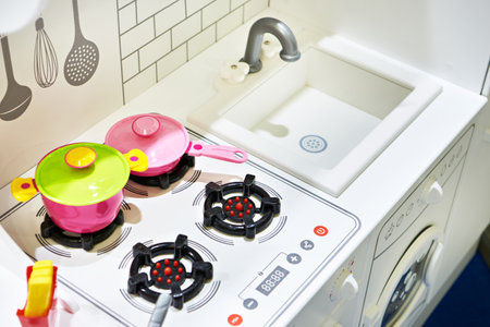 Children's toy kitchen with saucepan, frying pan, friesの写真素材