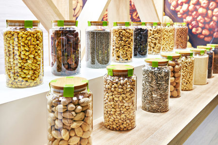 Assortment of nuts in glass jars in a shop windowの写真素材