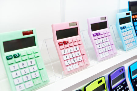 Colorful calculators on a showcase in a stationery storeの写真素材