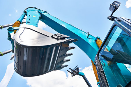 Excavator bucket hydraulics on sky backgroundの写真素材