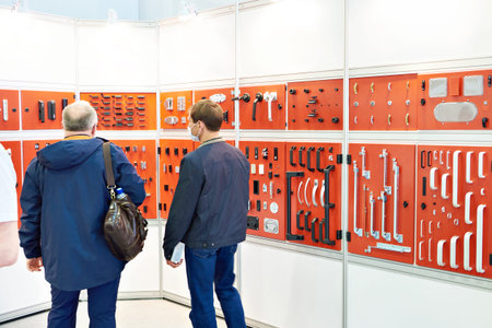 Men buyers in hardware store of locks and hinges for electrical box doors