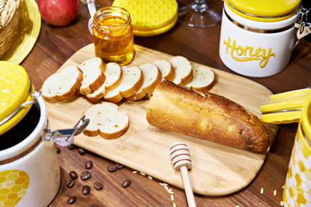 Still life with a jar of honey and sliced bread