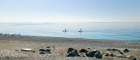 Seashore and people on Standup paddleboarding SUPの写真素材