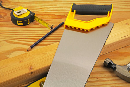 Carpenters bench -  A carpenter using a saw as a straight edge to mark a piece of wood