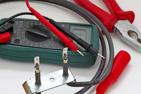 Appliance testing â An engineer fault finding an electric  oven heater element.の写真素材