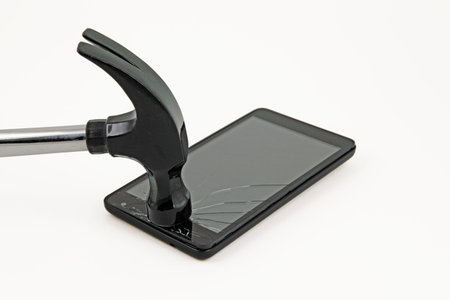 Claw hammer smashing glass of mobile phoneの写真素材