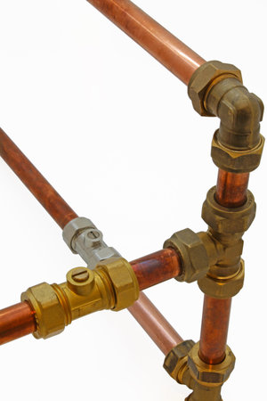 Copper pipework â€“  Copper pipe, compression and solder fittings isolated on a white...