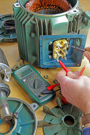 Three phase induction   motor bearing repair â€“ A fitter/technician  removing rotor from...