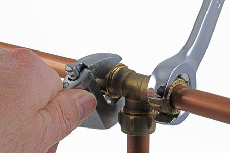 Wrenches, copper pipes and fittings.