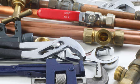 Random mixture of copper pipe, tools and brass fittingsの写真素材