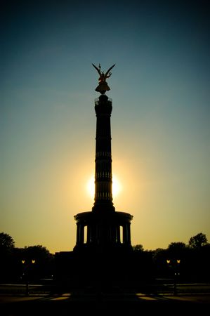 View at sunset of the golden statue of winged Victoria on top of the famous Victory Column (Siegessäule) monument. Berlin, Germany.の写真素材