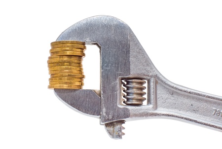 Golden coins and wrench isolated on white backgroundの写真素材