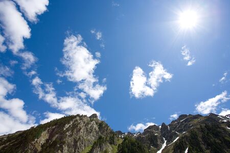 Blue sky with sun and clouds.の写真素材