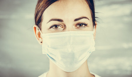 Close up portrait of a woman in a medical mask. A young woman prepared for the second wave of...