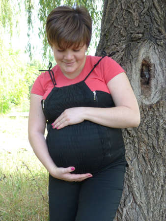 Young pregnant girl is walking around the city