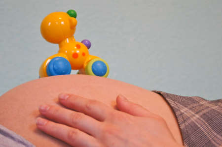 A fun toy on the abdomen of pregnant womanの写真素材