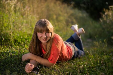 Young beautiful girl on a walk in the countryの写真素材