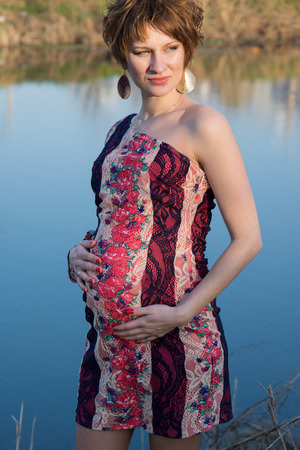 The pregnant girl on walk in city parkの写真素材