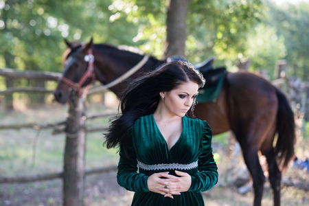 Young beautiful girl with a horse on natureの写真素材