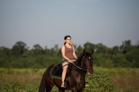 Young beautiful girl with a horse on natureの写真素材