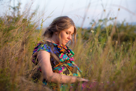 photo session in the nature cute pregnant girlの写真素材