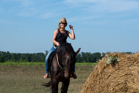 Young beautiful girl with a horse on natureの写真素材