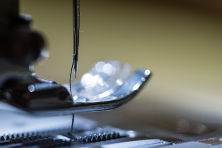 A macro shot of the needle and thread on an electric sewing machine.の写真素材