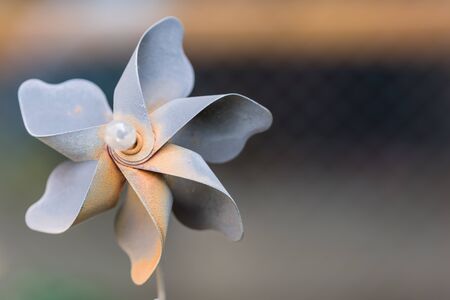 A decorative pinwheel garden ornament made of rusted metal.の写真素材