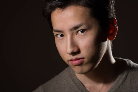 A headshot of a young handsome Japanese man.の写真素材