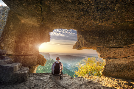Traveler relax in mountain cave. Conceptual design.の写真素材