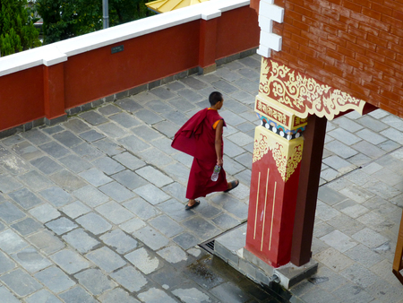 Tibetan monk walk in the templeの写真素材