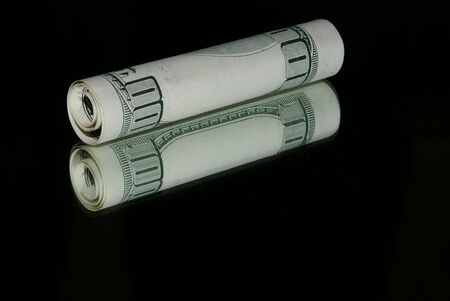 close-up of a twisted 100 dollars on the mirror