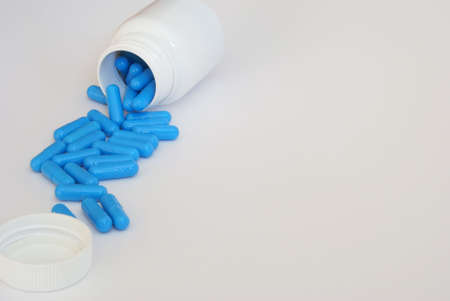 blue pills close-up over light backgroundの写真素材