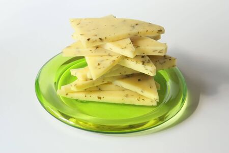 sliced cheese stack on the green plate close-upの写真素材