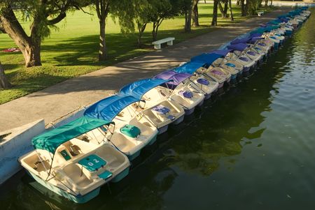 Row of the catamarans in the pond of the city park
